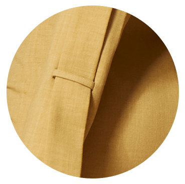 Waistband detail of mustard women’s trousers