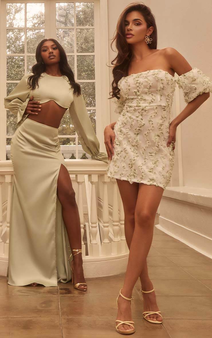 Two women wearing cream dresses