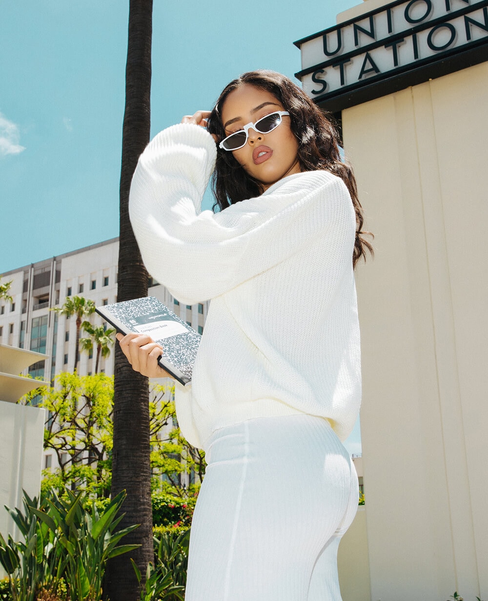 white knitted long sleeve jumper and white culottes mobile